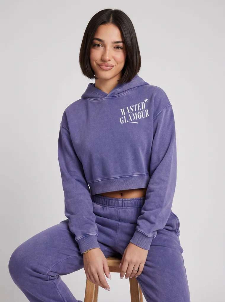 A washed violet cropped hoodie with a butterfly back print and matching sweatpants on pale grey. Cropped Hoodie Set in Violet, frame 3 of 5
