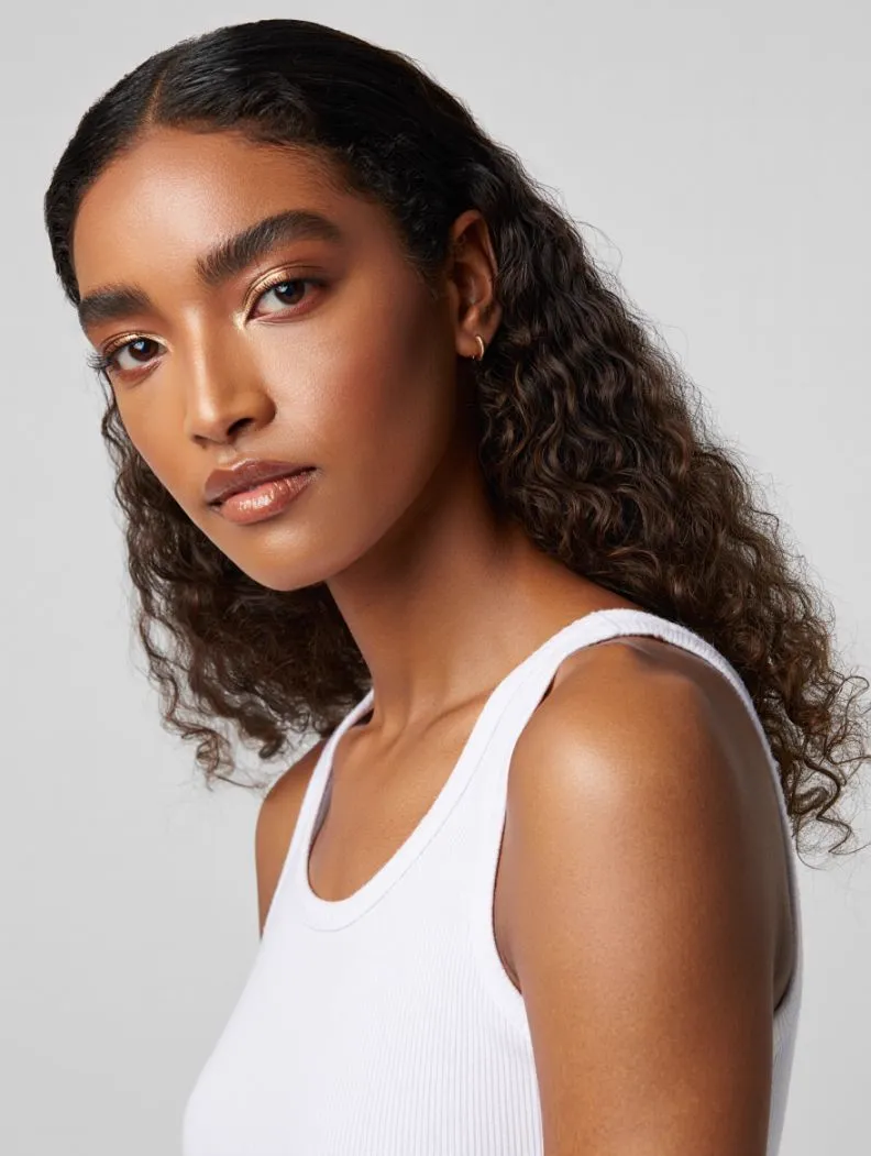 Face reference — woman with curly hair, neutral expression