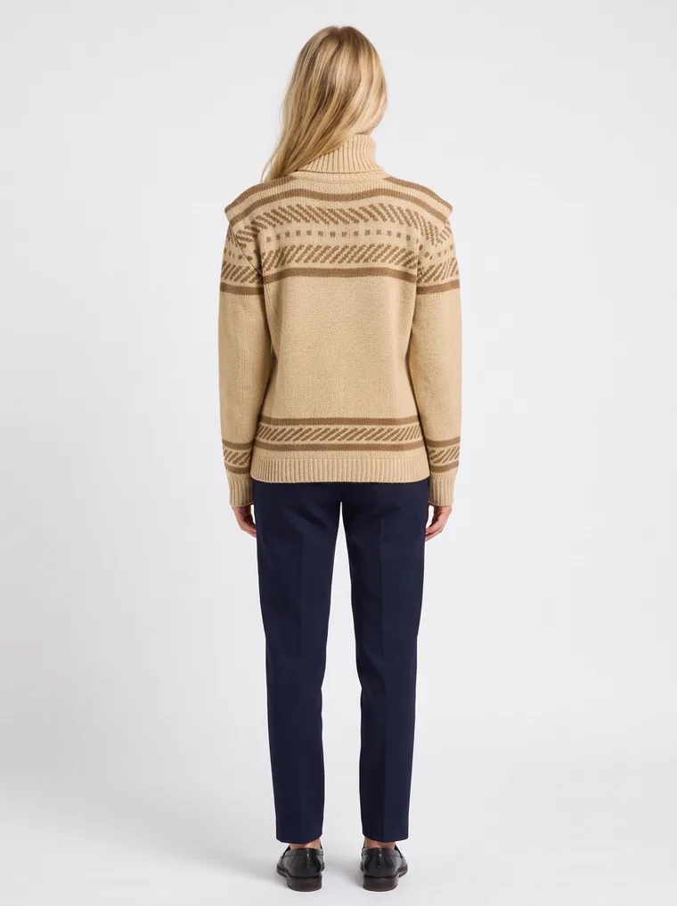 A beige mock-neck knit with brown Fair Isle jacquard bands across the yoke and hem, worn with navy trousers. Fair Isle Mock-Neck Knit in beige, back view, full length