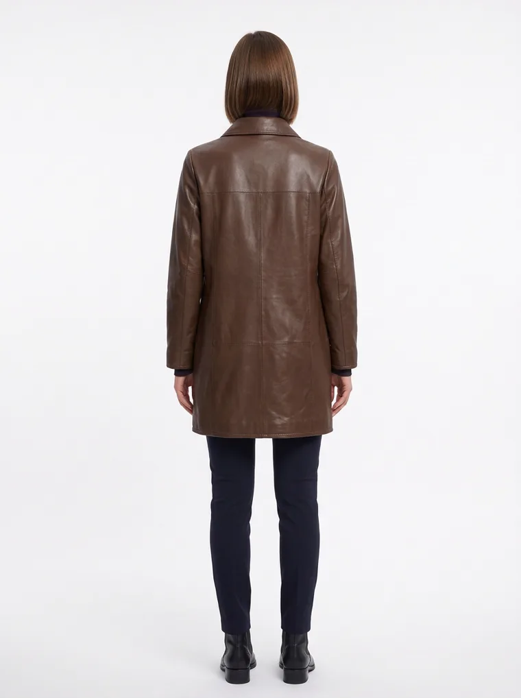 A brown leather car coat with a point collar, button front and quilted lining, worn with a black roll neck and black trousers. Leather Car Coat in brown, back view