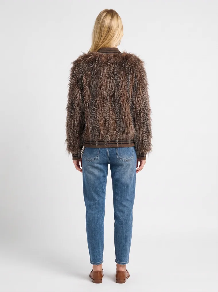 The back of a shaggy brown faux-fur jacket on a model, the long pile reading as one continuous surface