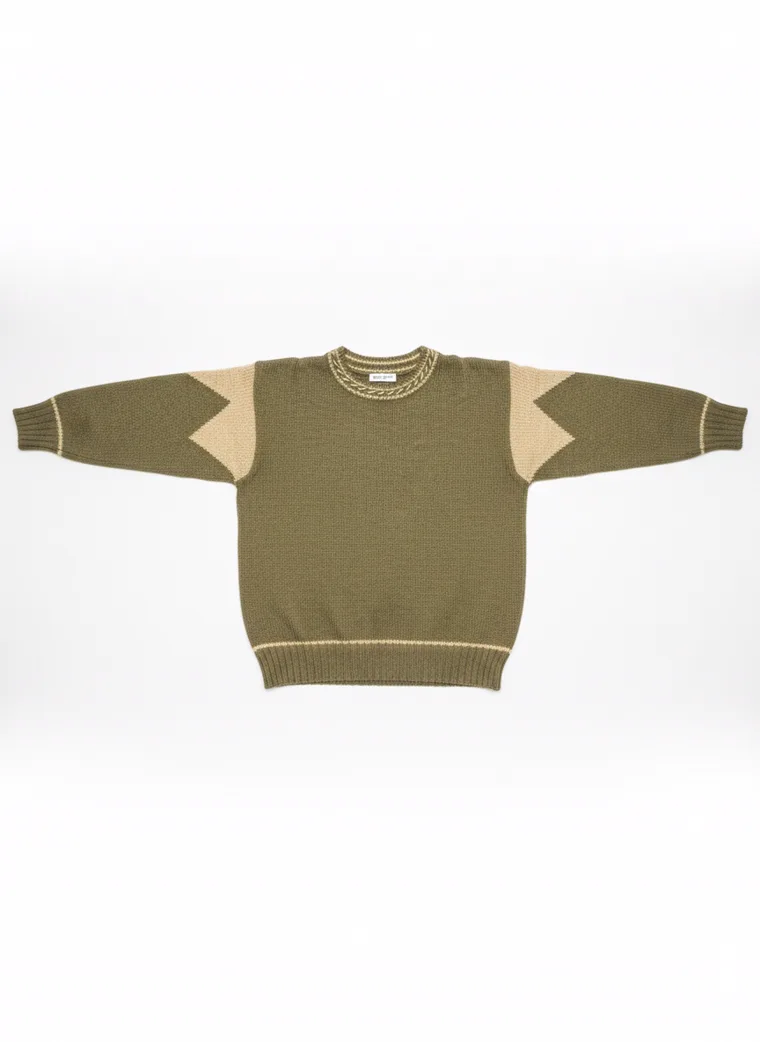 An olive crew-neck knit with tan contrast shoulder panels and cream tipping at the neck and cuffs, worn with black trousers. Knit with Contrast Panels in olive, laid flat