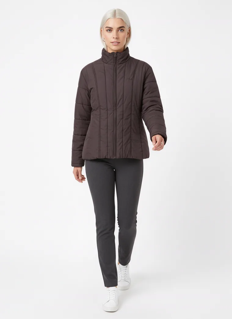 A model walking in a dark brown channel-quilted puffer jacket that keeps its shape