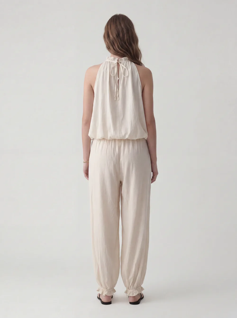 MODA catalog shot 3 of 10 — the generated model in the cream halter jumpsuit, consistent across every angle