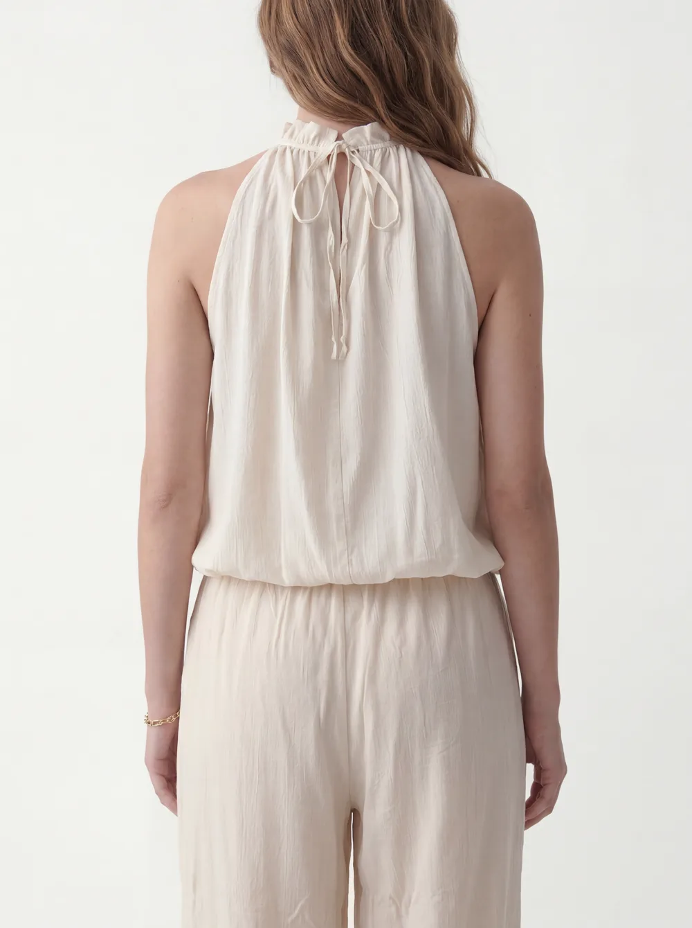 MODA catalog shot 5 of 10 — the generated model in the cream halter jumpsuit, consistent across every angle